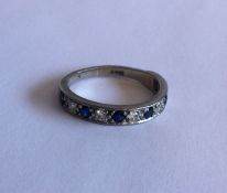 A sapphire and diamond eleven stone half eternity