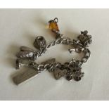 A silver curb link charm bracelet with heart shape