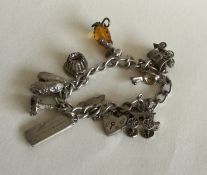 A silver curb link charm bracelet with heart shape