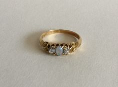 A Victorian opal and diamond three stone ring in c