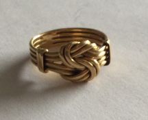 An 18 carat gold keeper ring of typical form. Appr