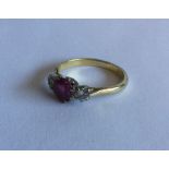 An attractive ruby and diamond three stone ring in
