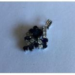A large sapphire and diamond pendant of stylised f