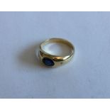 A sapphire and diamond three stone gypsy set ring