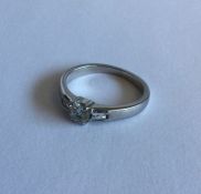 An attractive diamond single stone ring in claw mo