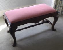 A mahogany duet stool with pink slip-in seat. Est.