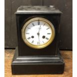 An Edwardian ebony mantle clock with white enamell