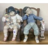 Two Lladro figures of children dozing in a rocking