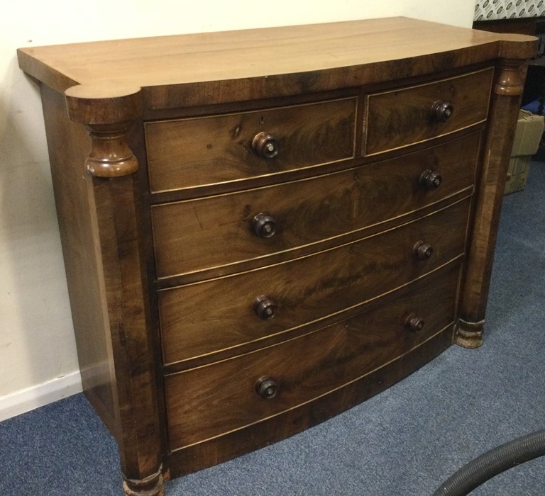 A flame mahogany chest of five drawers with shaped