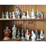 A shelf of decorative porcelain clowns. £15 - £20.