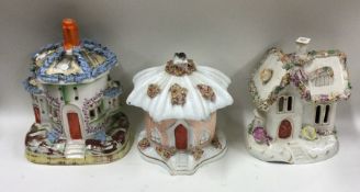 A group of three Staffordshire houses. Est. £20 -