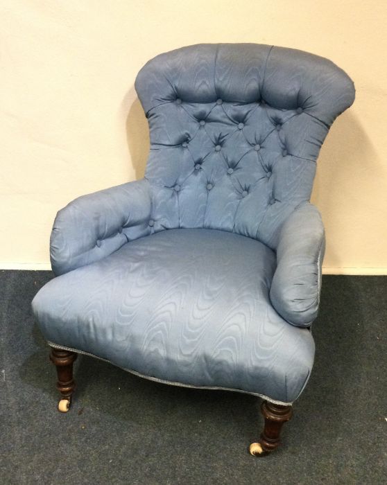 A Victorian button backed nursing chair on turned