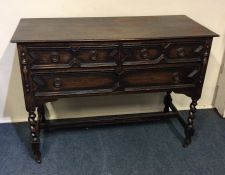 An oak three drawer chest on barley twist supports