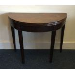 A good Georgian mahogany bow front card table on t