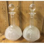 A pair of baluster shaped cut glass decanters with