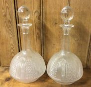 A pair of baluster shaped cut glass decanters with