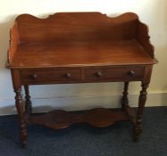 A Victorian two drawer mahogany writing desk on tu