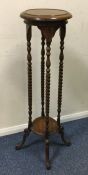 A mahogany pedestal plant stand with barley twist