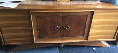 A massive retro four door sideboard on sweeping ba