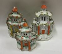 A large tapering set of three Staffordshire houses