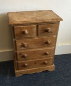 A small pine five drawer chest with turned handles