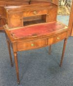 A 20th Century mahogany bow front two drawer desk.