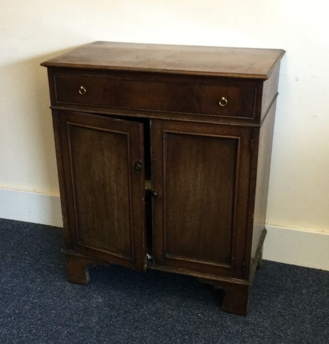 A Georgian mahogany two door cupboard with single