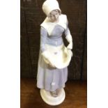 A decorative figure of a lady in blue dress. Est.