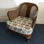 A cane back conservatory chair. Est. £20 - £30.