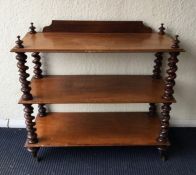 A Victorian mahogany buffet with turned supports.