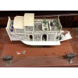 An unusual carved ivory model of a boat in glazed