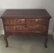 An early Georgian three drawer chest with shaped e
