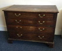 A large Georgian mahogany chest of four drawers on