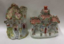 A pair of unusual Staffordshire figures of houses.