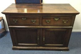 A heavy Georgian oak two drawer sideboard with pla