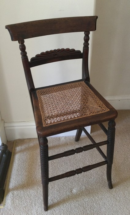 A rosewood mounted correction chair with cane seat
