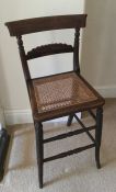 A rosewood mounted correction chair with cane seat