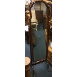 A shaped mahogany dressing mirror. Est. £30 - £50.