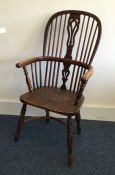 A large Antique bow back chair of typical form. Es