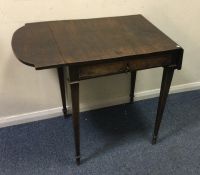 An Antique mahogany drop leaf table of shaped form