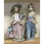 Two large Lladro figurines of children on green fl
