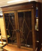 A good mahogany bookcase with panelled fronts. Est