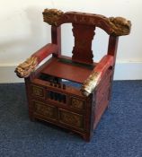 A red lacquered child's chair. Est. £30 - £50.