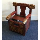 A red lacquered child's chair. Est. £30 - £50.