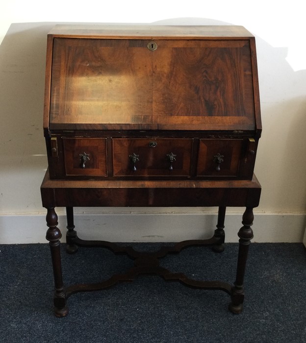 A good early Georgian three drawer bureau with ven