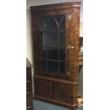 A large walnut veneered corner cupboard with bevel