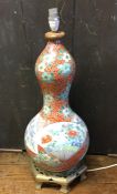 A tall Chinese baluster shaped vase decorated in b