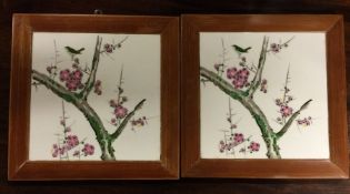 A pair of framed tiles of Chinese design decorated