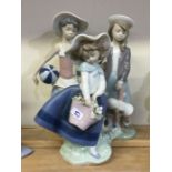 A group of three Lladro figurines of girls wearing
