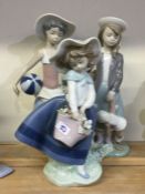 A group of three Lladro figurines of girls wearing